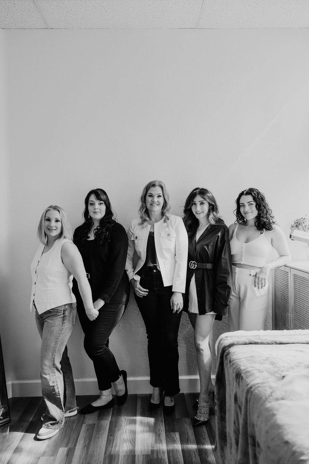 Five members of the Lash Candy team standing together in a lash room